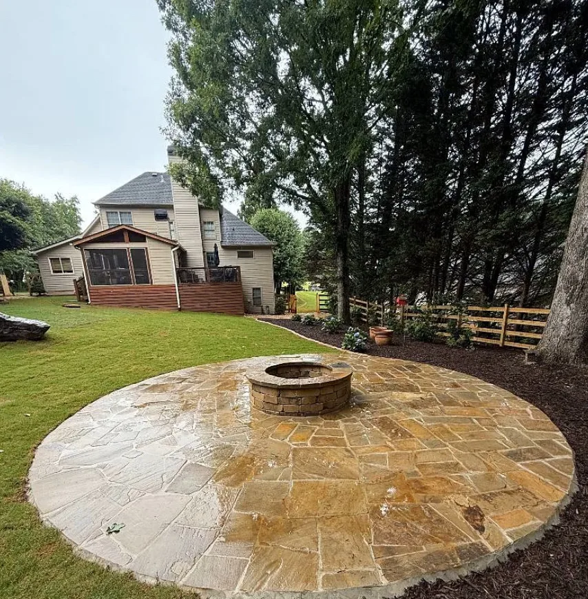 A circular flagstone patio and fire pit featured in a recent hardscape installation in Hoschton, GA.