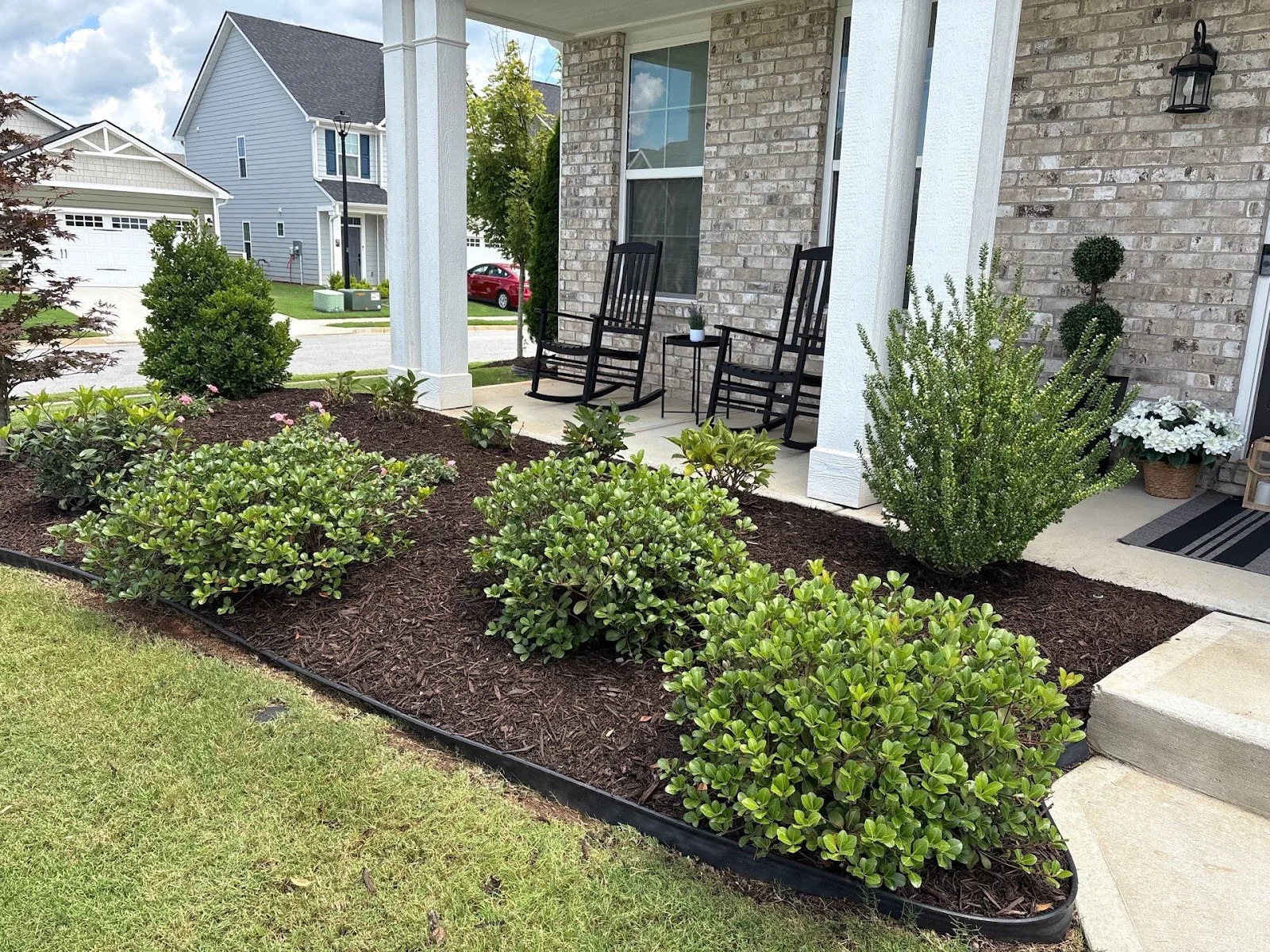 Front yard landscape design & installation in Watkinsville, GA with fresh mulch beds and green shrubs.